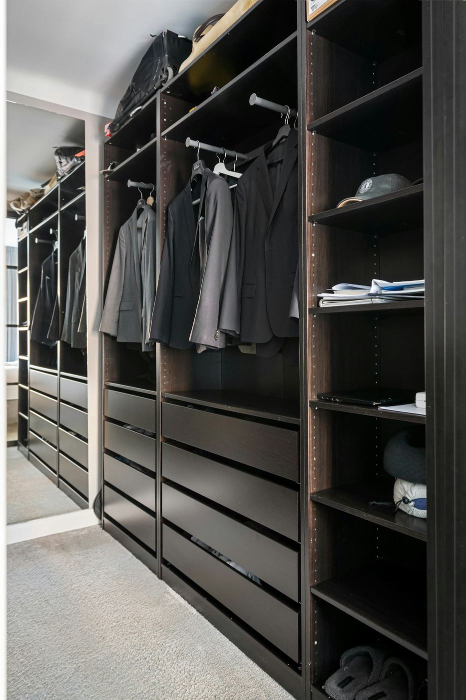 Fitted wardrobe run taken around a corner of the room with full-height doors